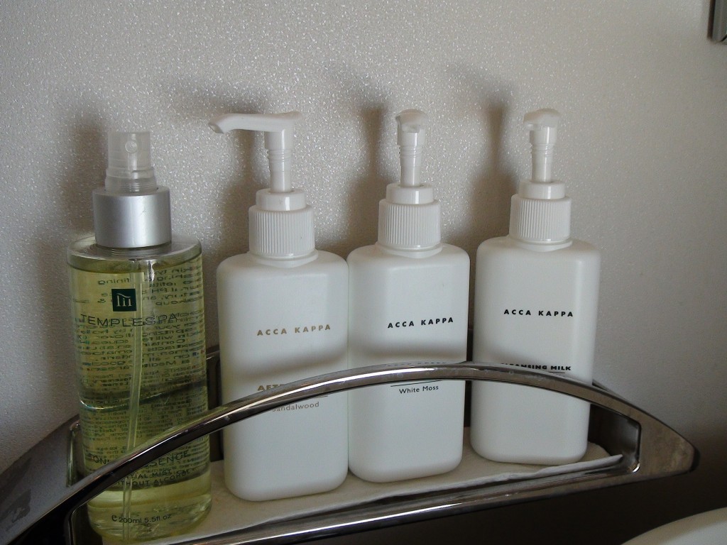 a group of white bottles on a metal shelf