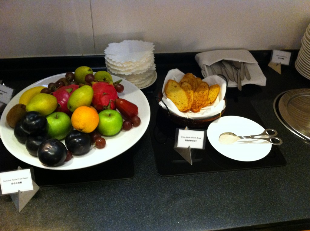 a plate of fruit and a bowl of chips