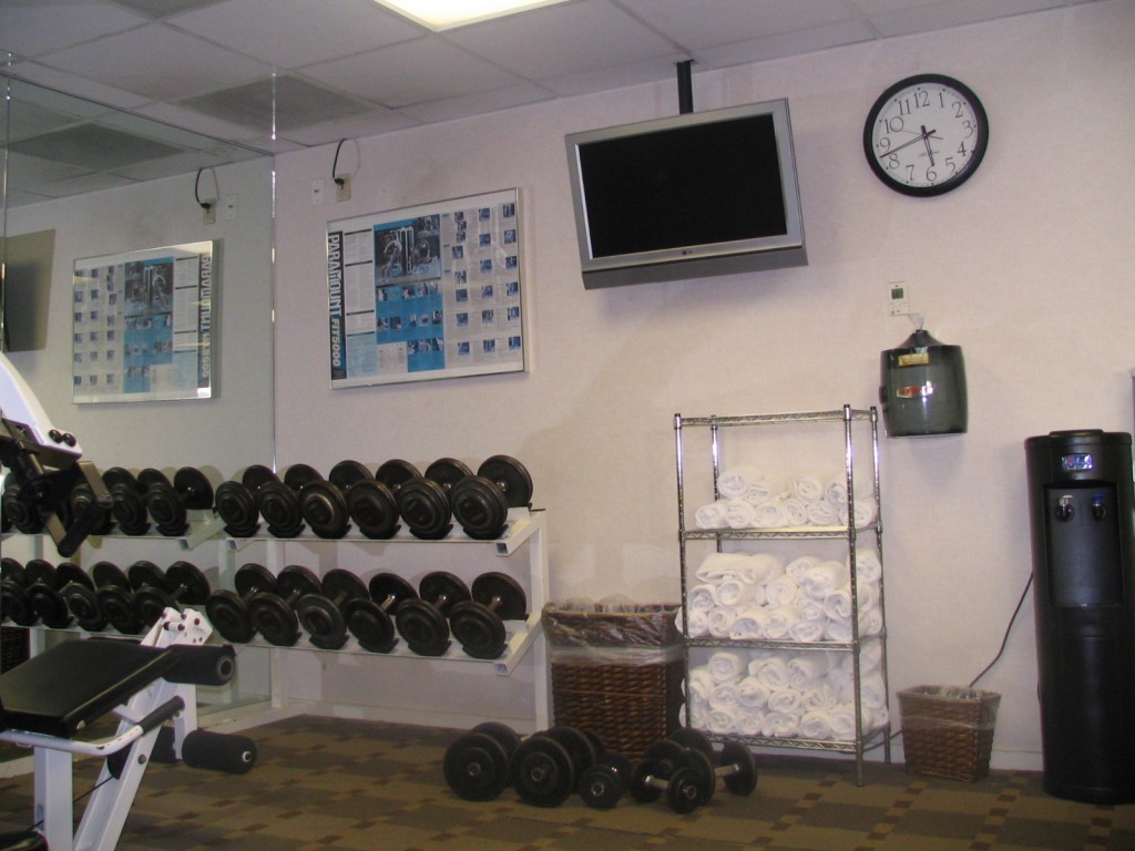 a room with a lot of weights and towels
