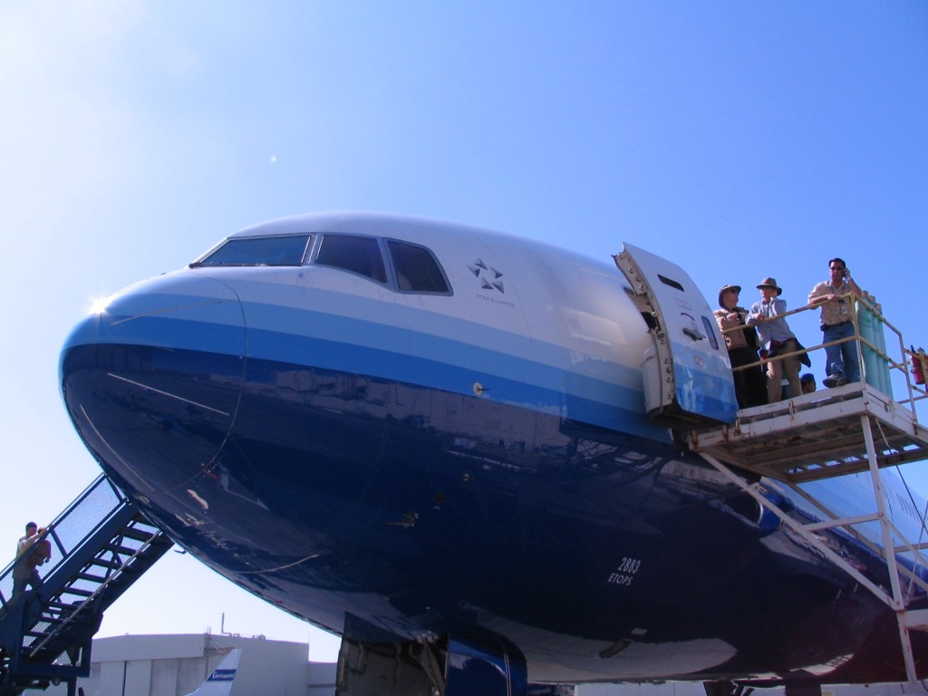 people standing on a ladder of a plane