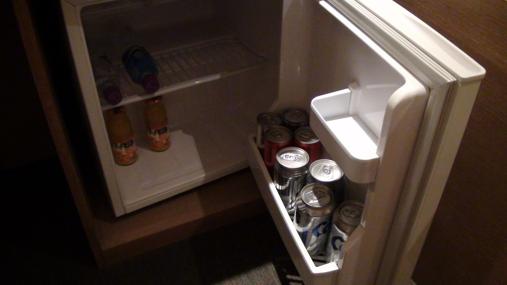 a refrigerator with cans and drinks