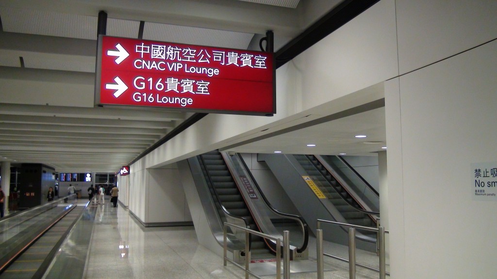 a sign in a building with escalators