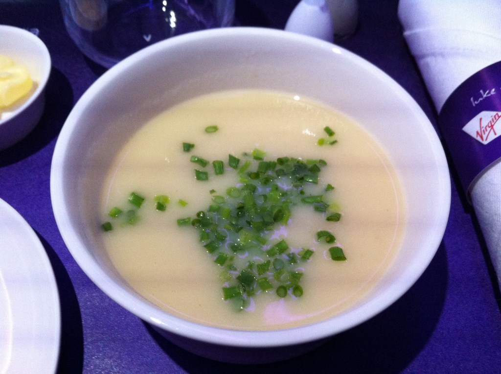 a bowl of soup with green onions