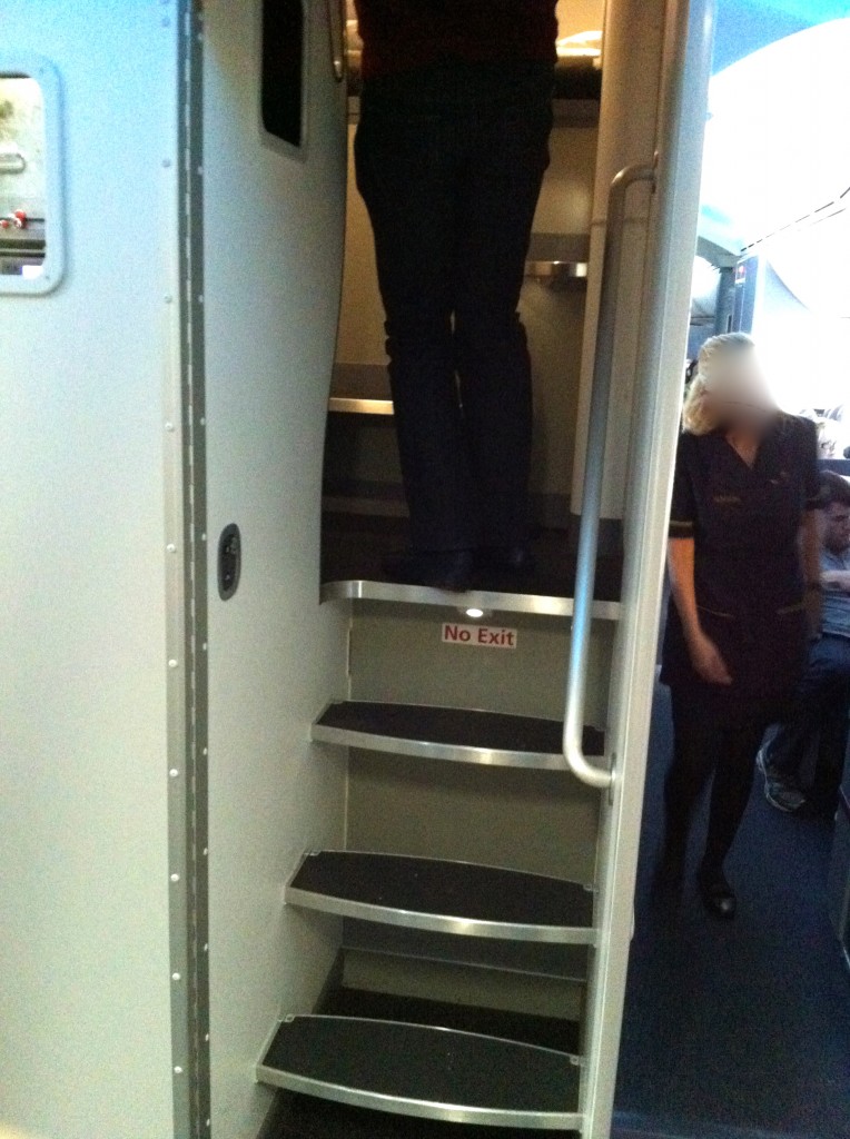a person standing on the stairs of a plane
