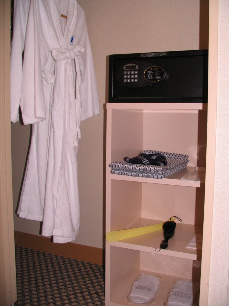 a white robe on a hook next to a safe
