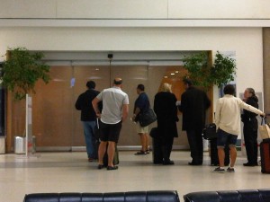 a group of people standing in front of a glass door