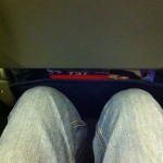 a person's legs in a plane