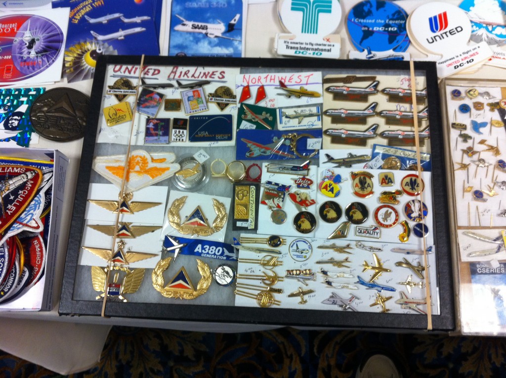 a display case with various pins and badges