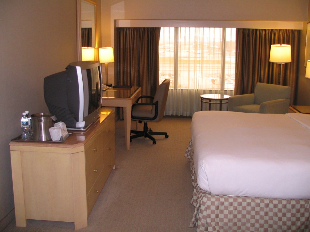 a hotel room with a tv and chair