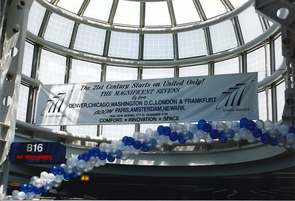 a banner with blue and white balloons