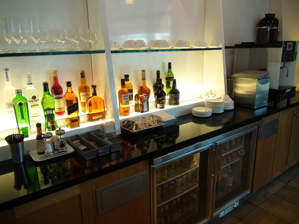 a bar with bottles of alcohol and glasses