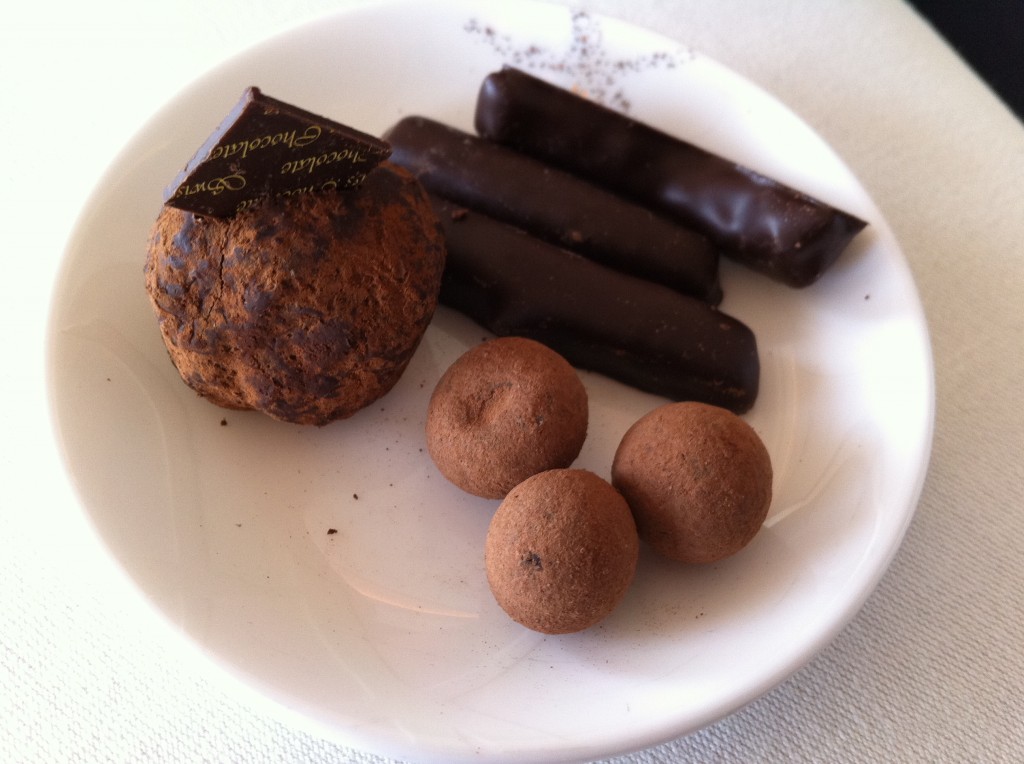 a plate of chocolate candies and a cookie