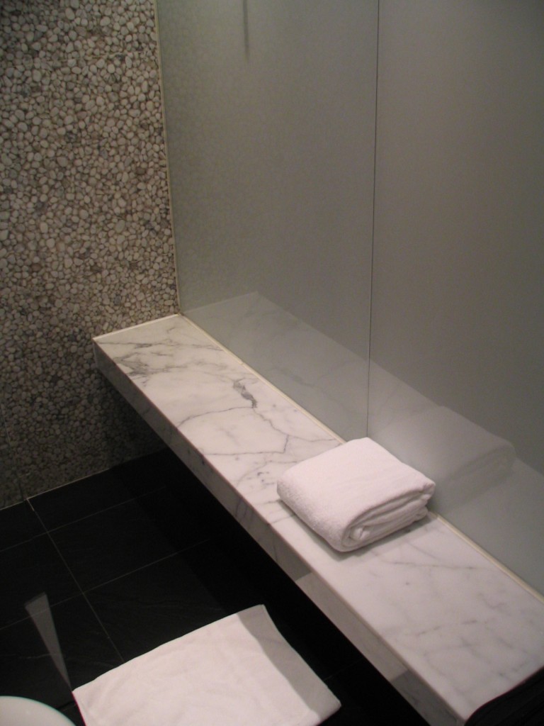 a white towel on a marble bench