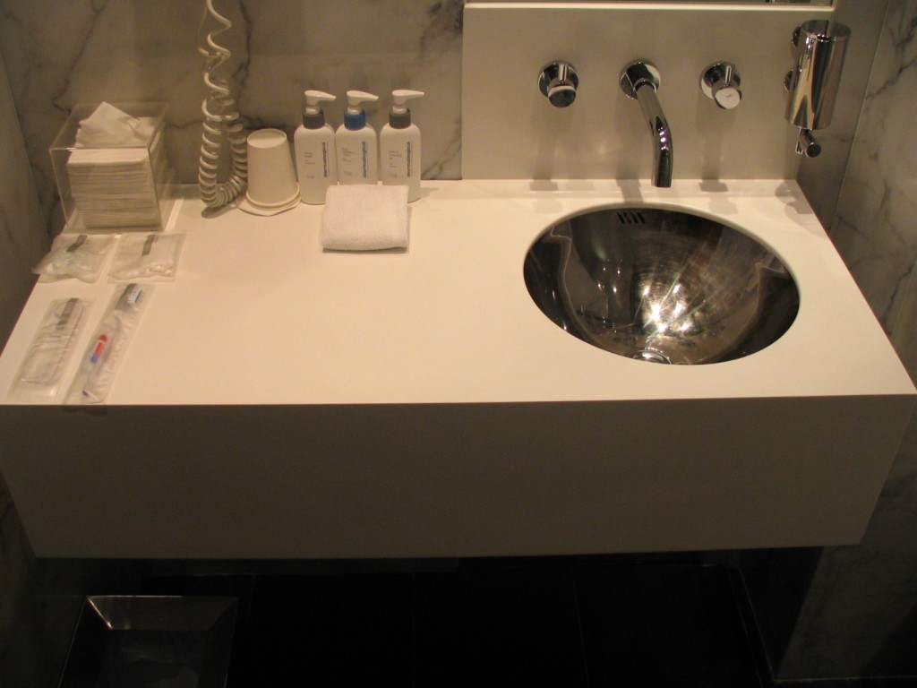 a sink with a faucet and soaps