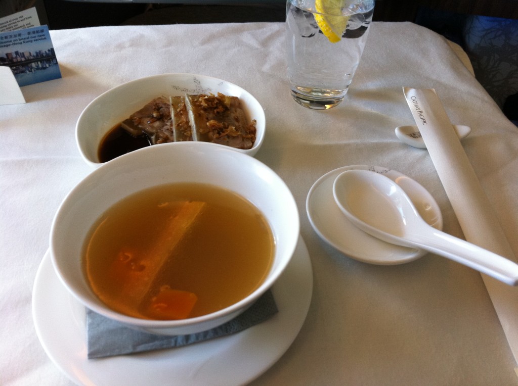 a bowl of soup and spoons on a table