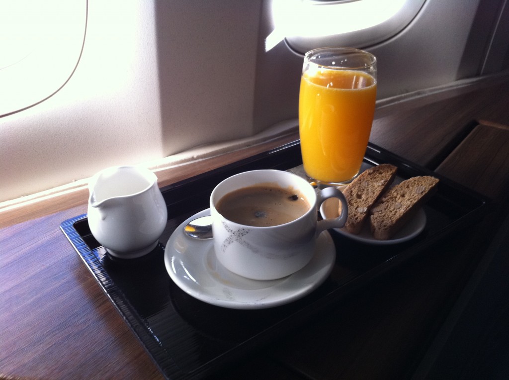 a coffee and orange juice on a tray