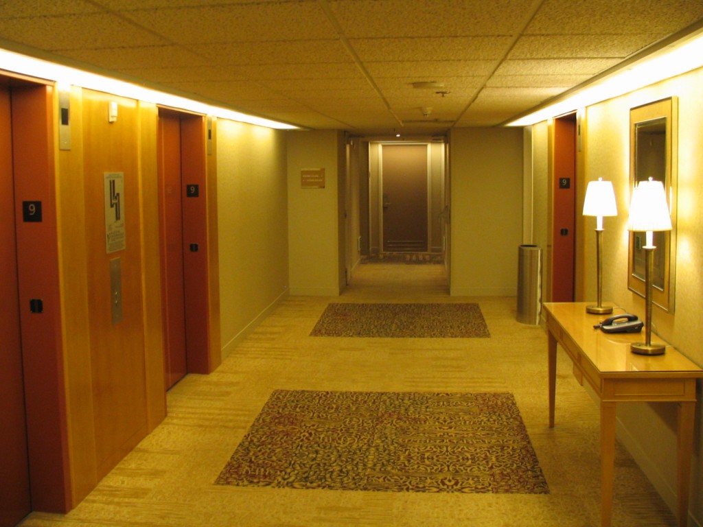 a hallway with doors and a lamp