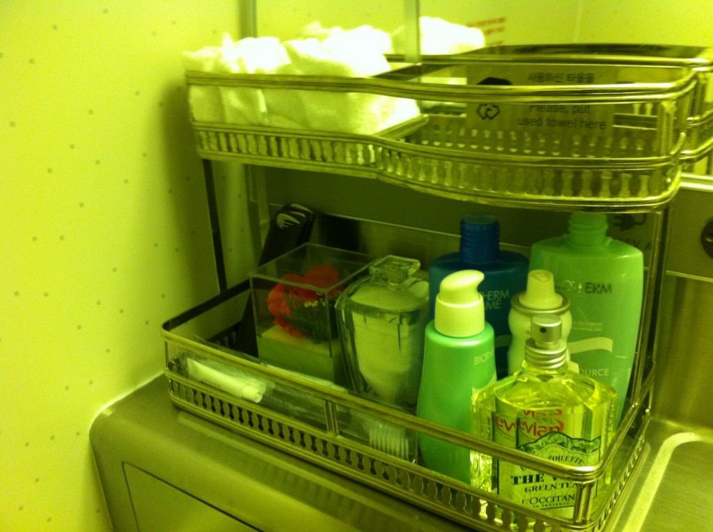 a bathroom shelf with a few bottles of shampoo and other items