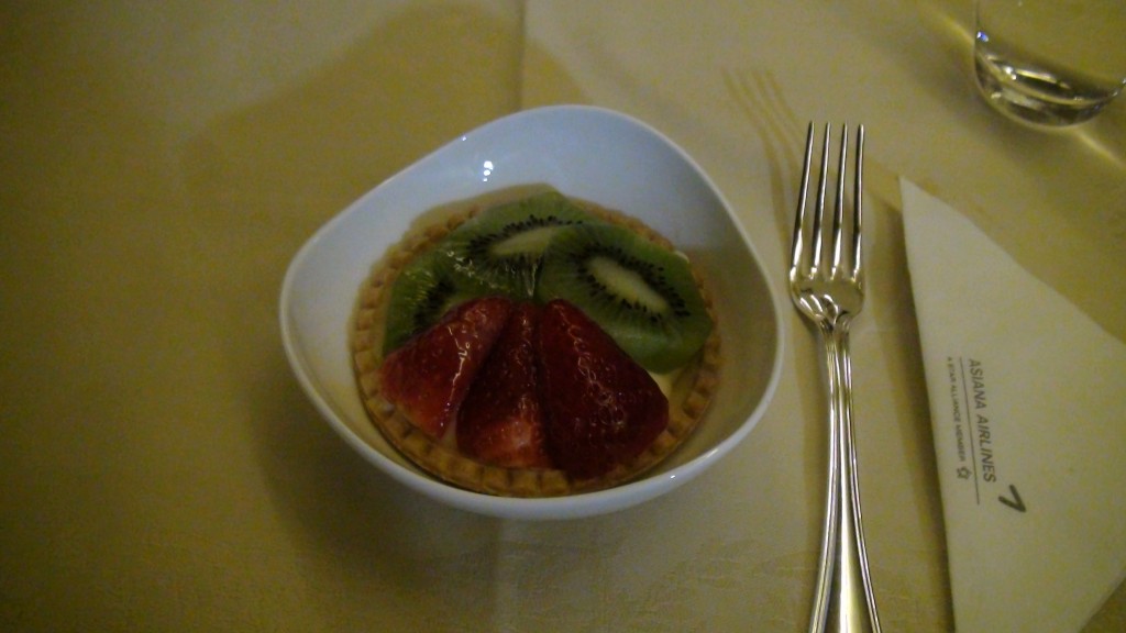 a bowl of fruit in a bowl next to a fork