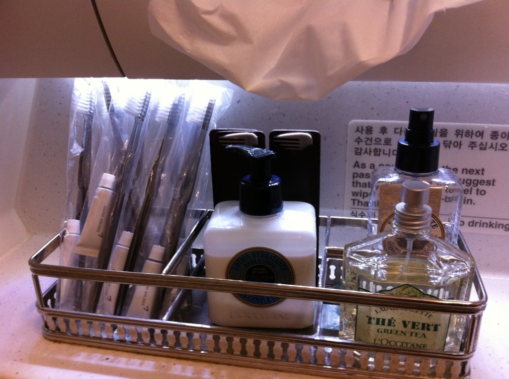 a bathroom shelf with toiletries and toothbrushes