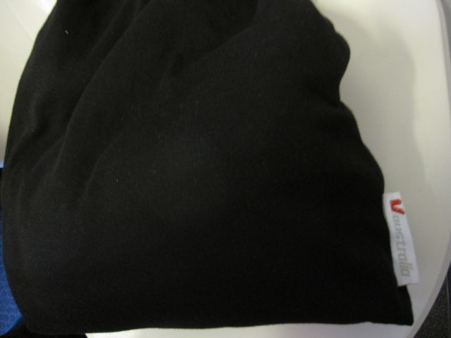 a black pillow with a white tag