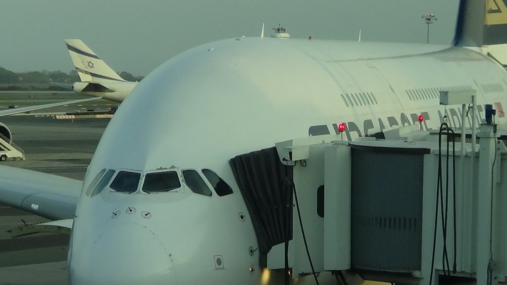 a large white airplane with a tunnel on the side