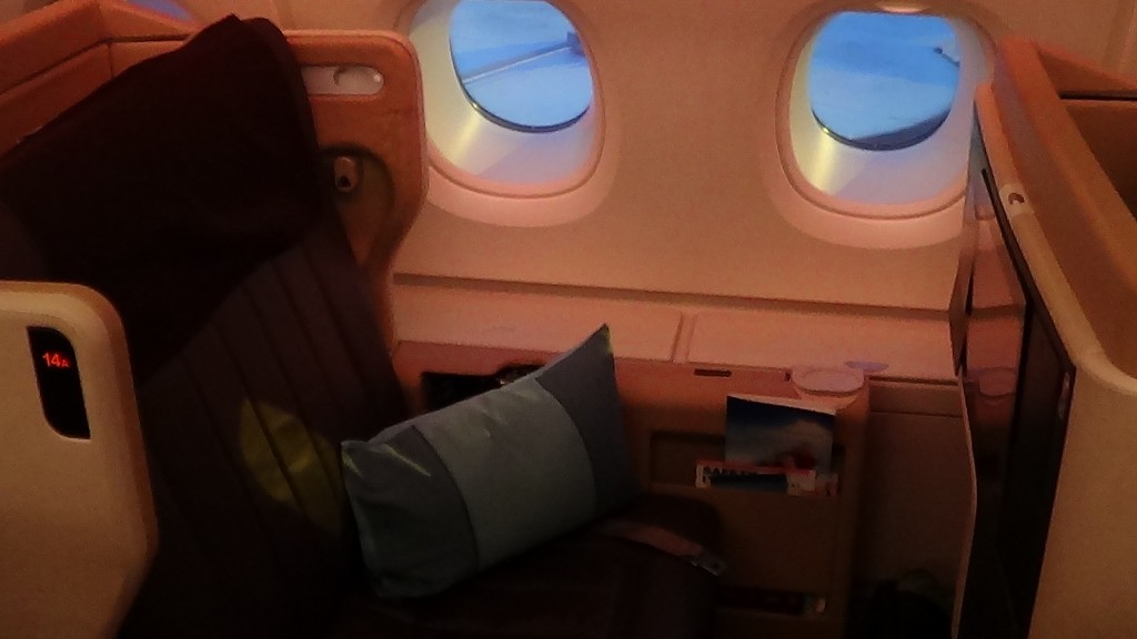 a seat with a pillow and a window with windows