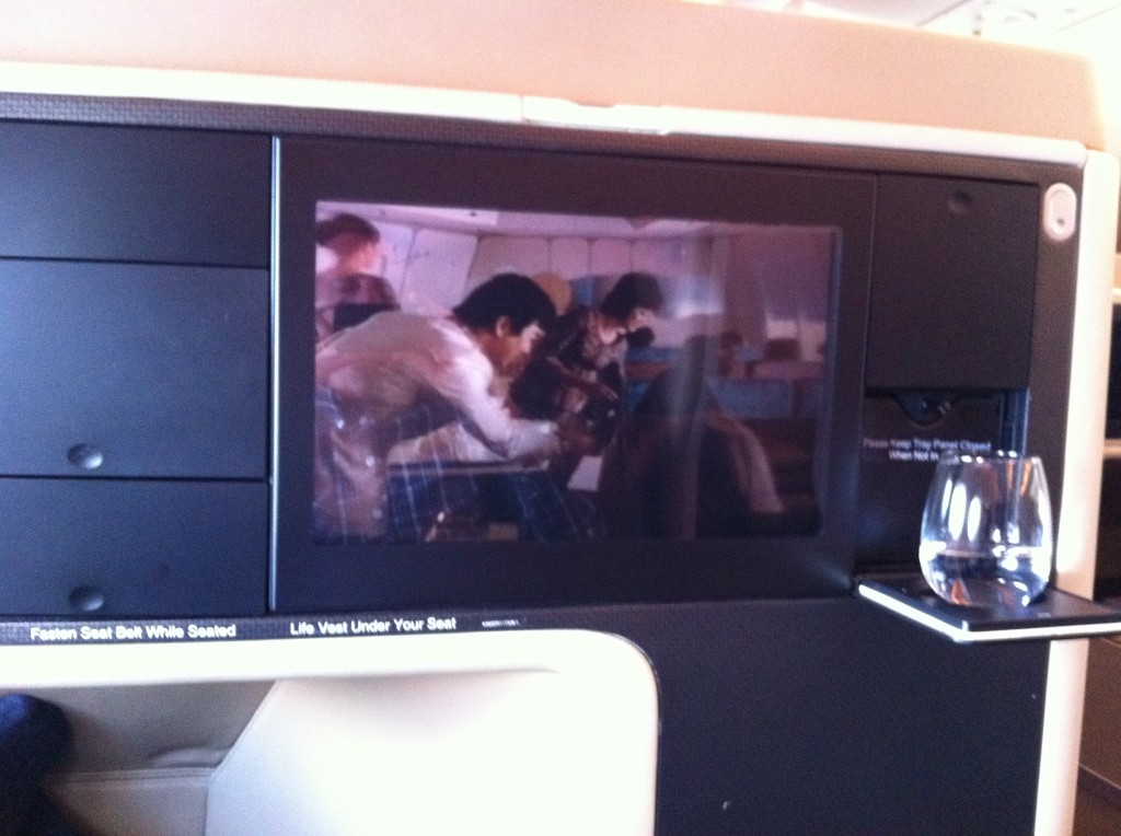 a tv on the shelf of an airplane