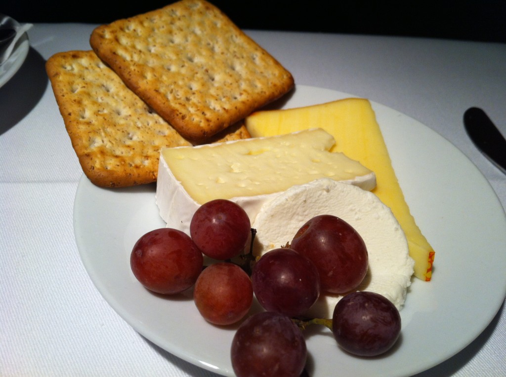 a plate of cheese crackers grapes and crackers