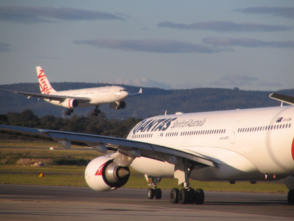 a couple of white airplanes on a runway