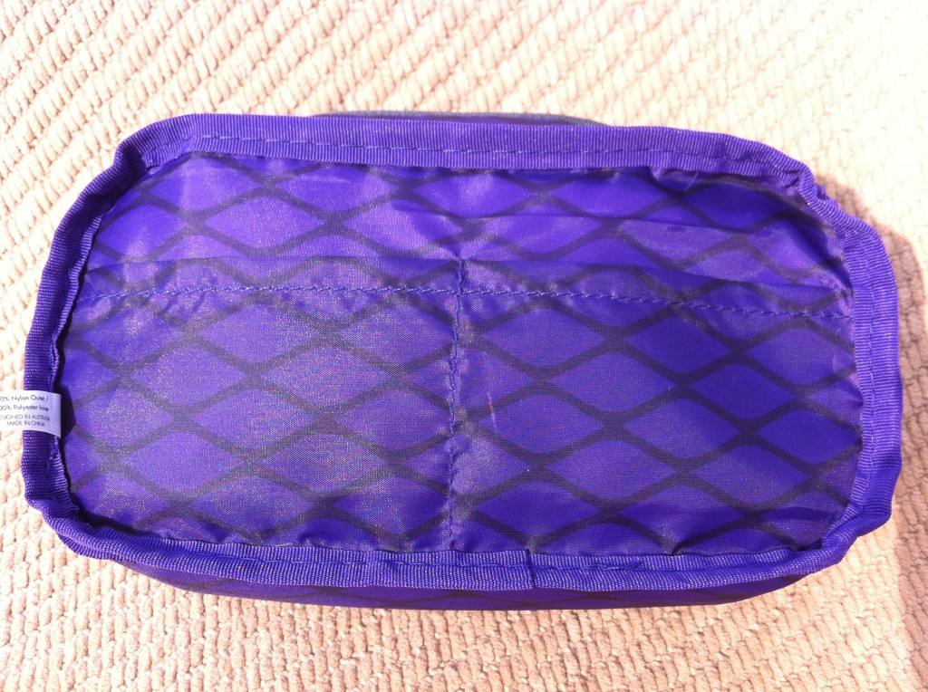 a purple bag on a tan surface