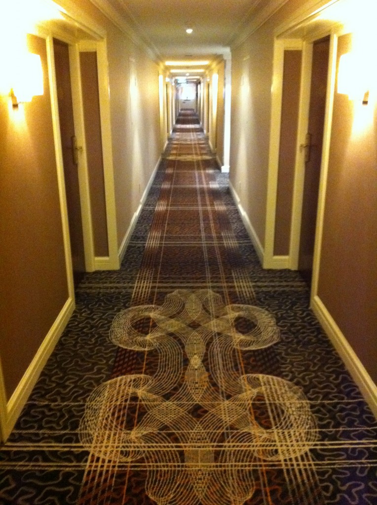 a long hallway with patterned carpet
