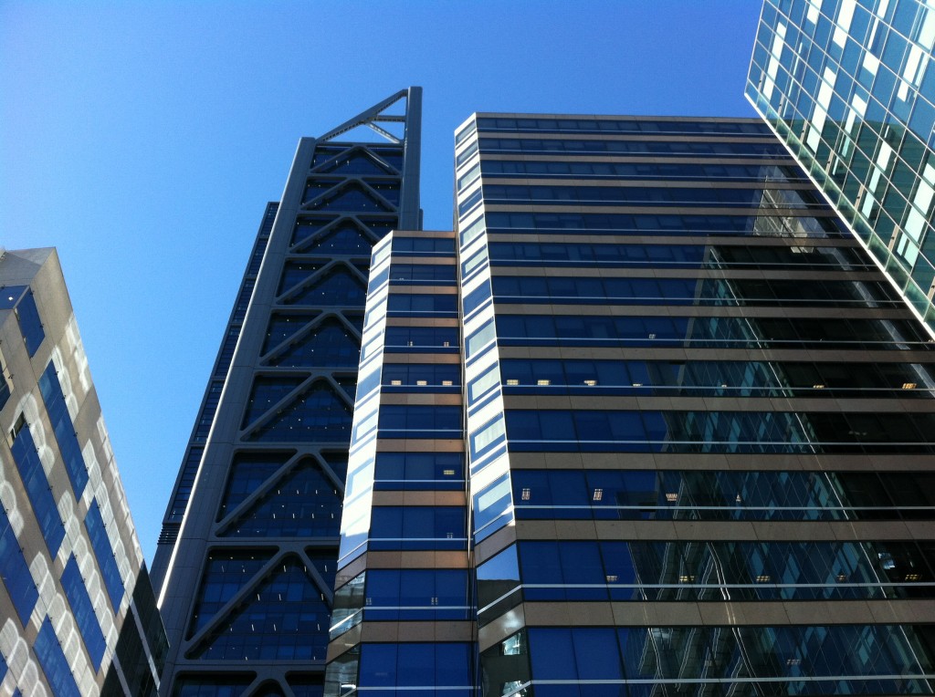 a group of tall buildings with blue glass windows