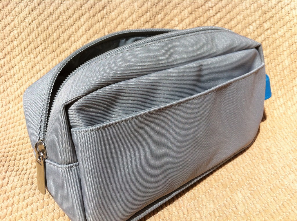 a grey bag on a tan surface