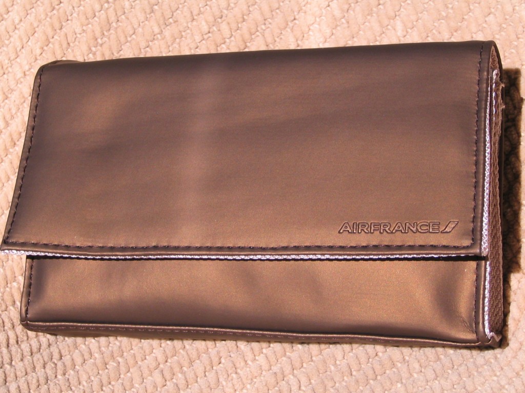 a brown leather wallet on a tan surface