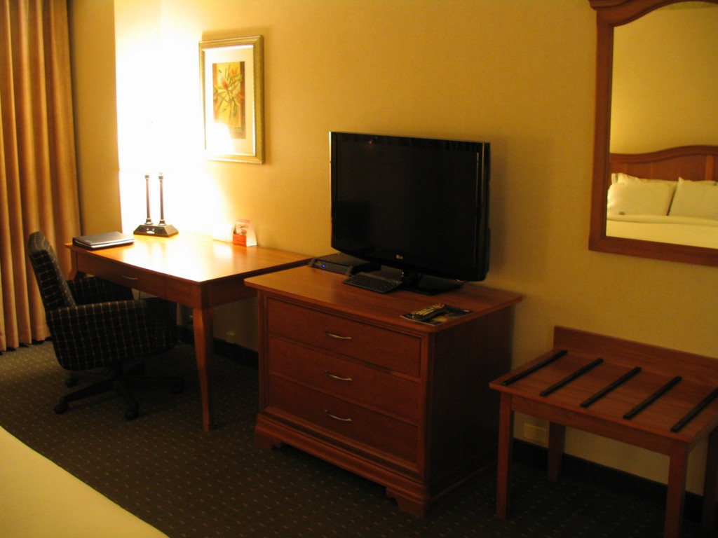 a room with a desk and a television