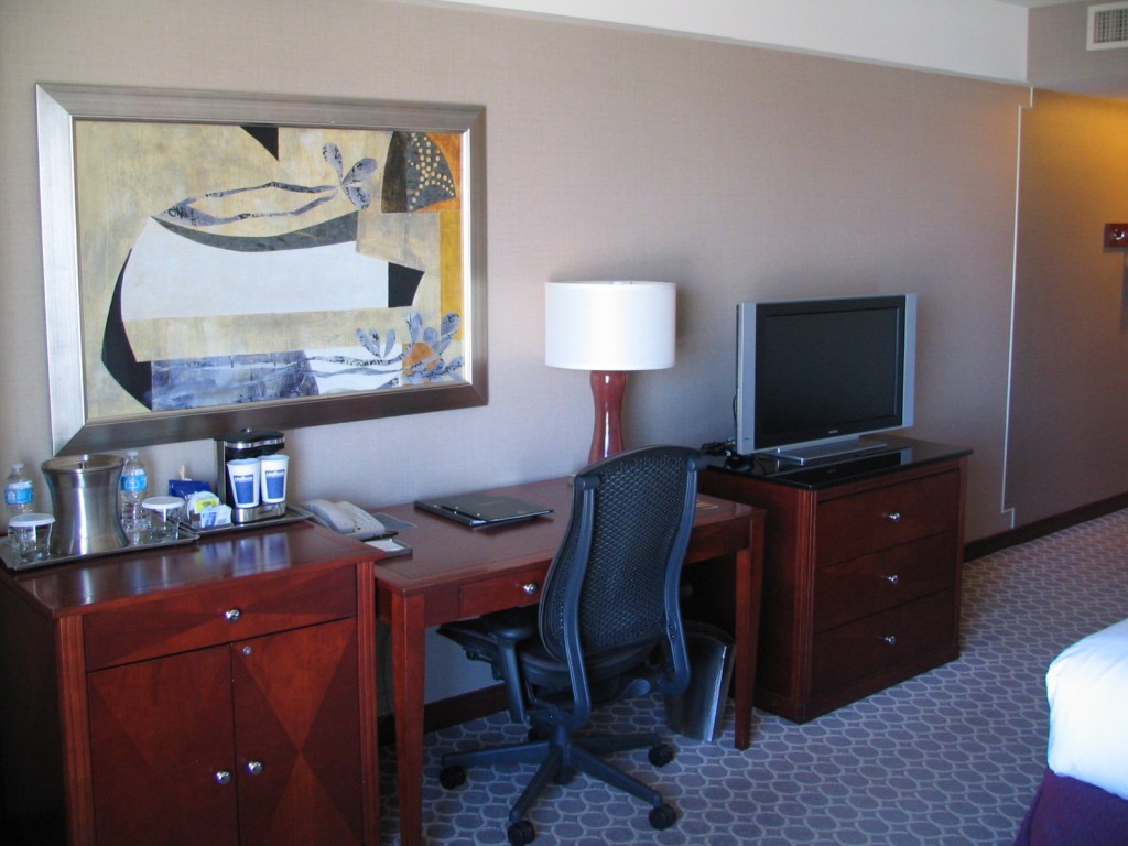 a desk and a tv in a hotel room
