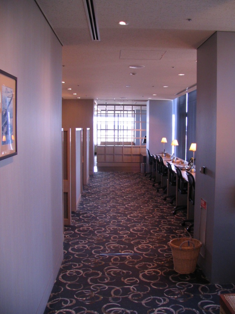 a long hallway with chairs and lamps