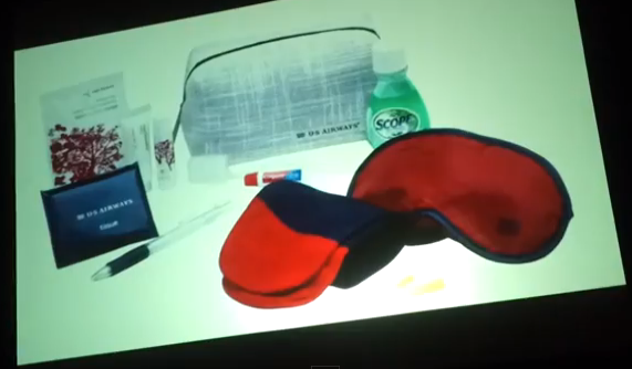 a red and blue sleeping mask and a pen on a white surface
