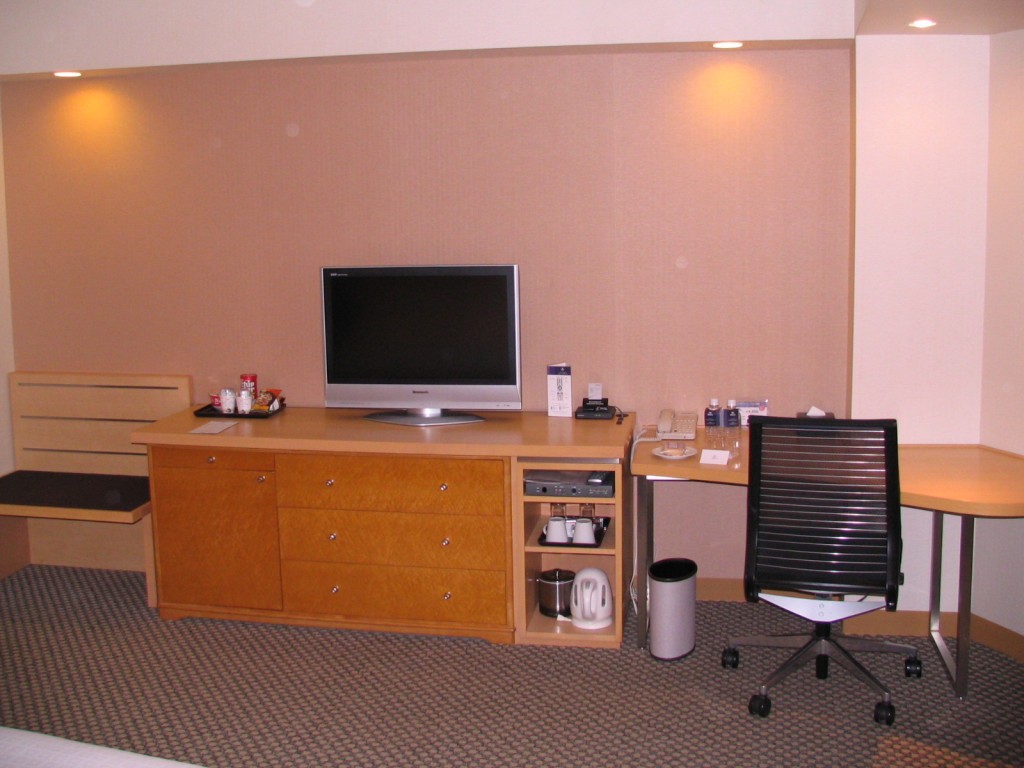 a room with a television and desk