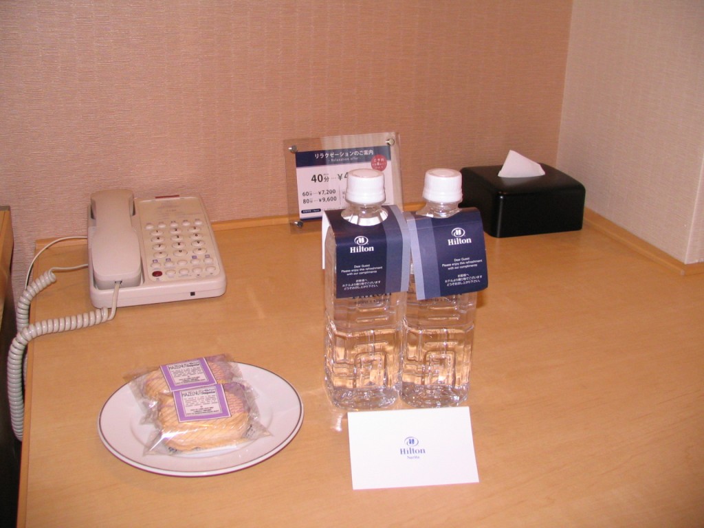 a table with a phone and water bottles