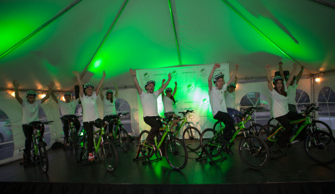 a group of people riding bicycles under a tent
